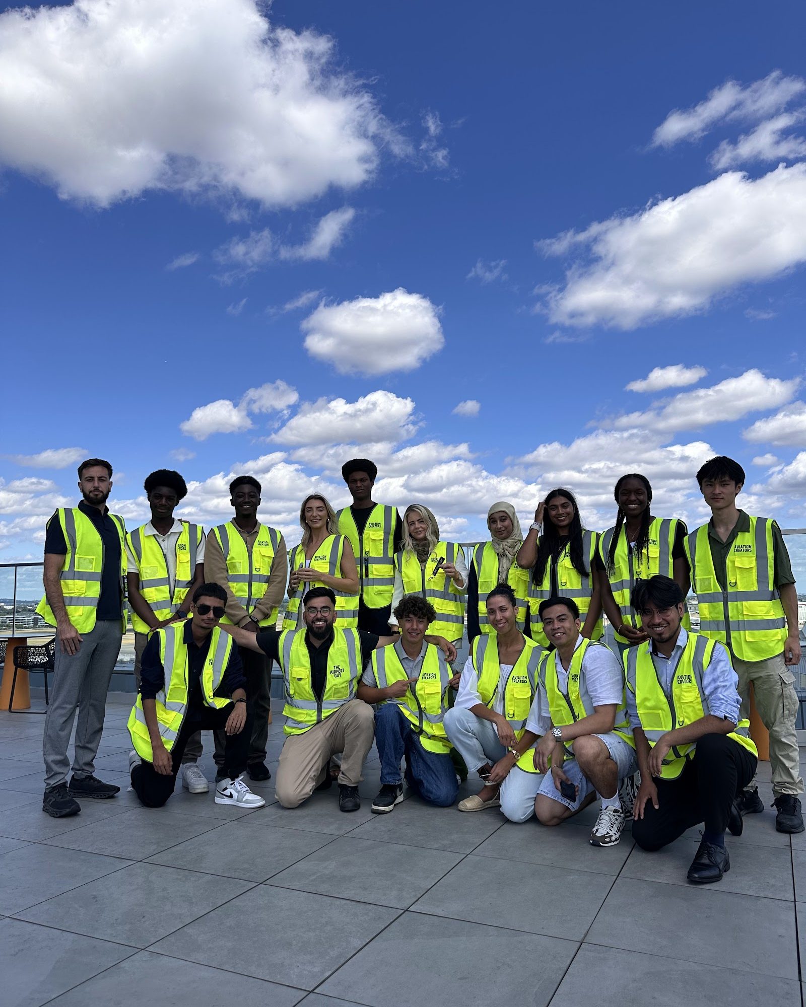 Aviation creators in hi-vis on an airport rooftop during a community day