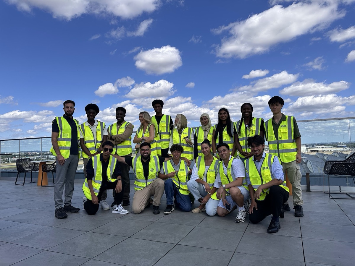 Creators posing together on the airport observation deck